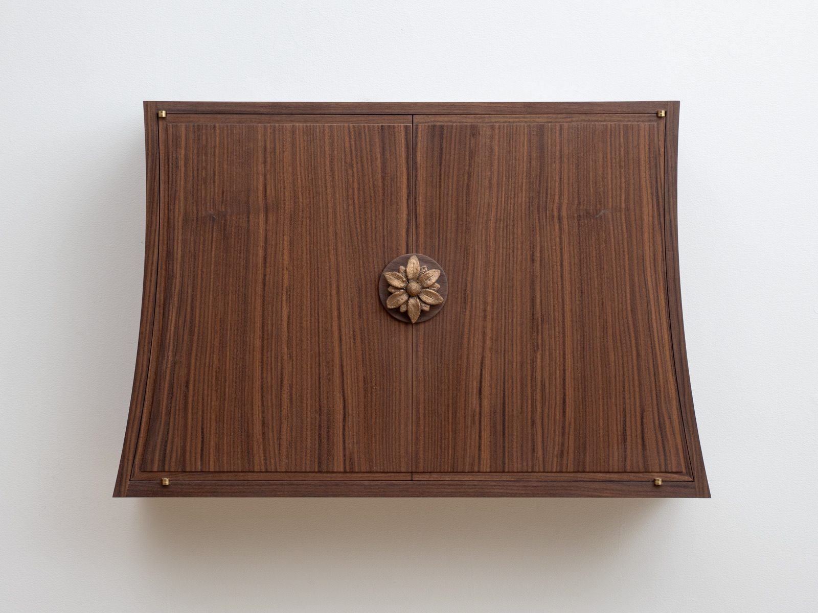 Gala — walnut wall cabinet with hand-forged bronze flower
