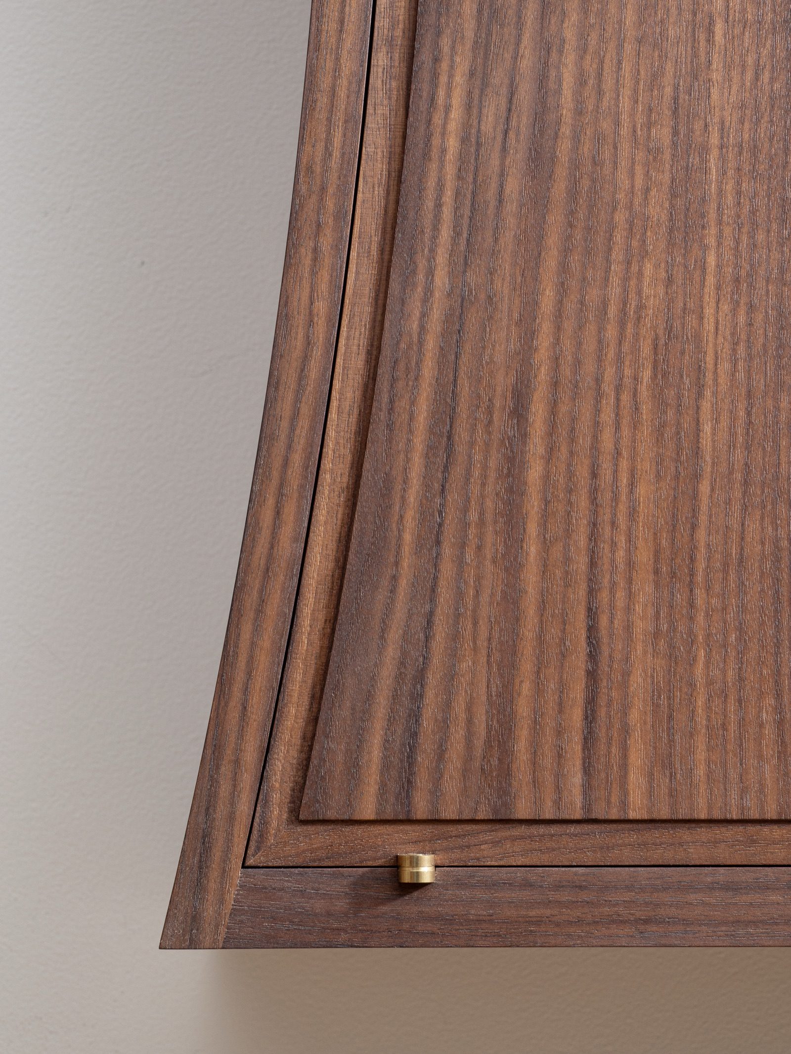 Gala — walnut grain and brass hinge detail