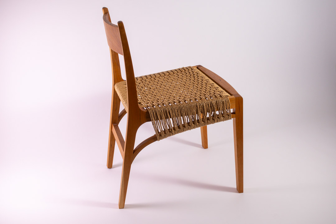 Lupin Chair — side view showing curved rear legs
