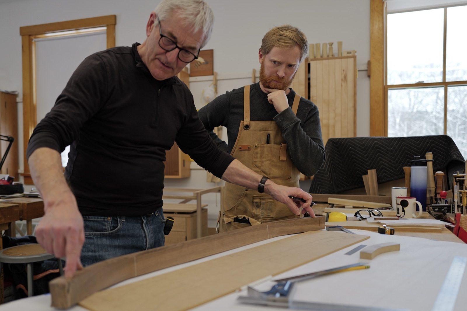 Spencer and instructor reviewing the Two Sons bench design